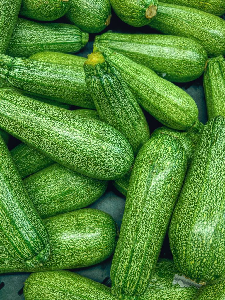 Vibrant close-up of fresh green zucchinis showcasing texture and color.